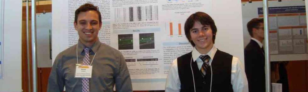2 students standing in front of research poster